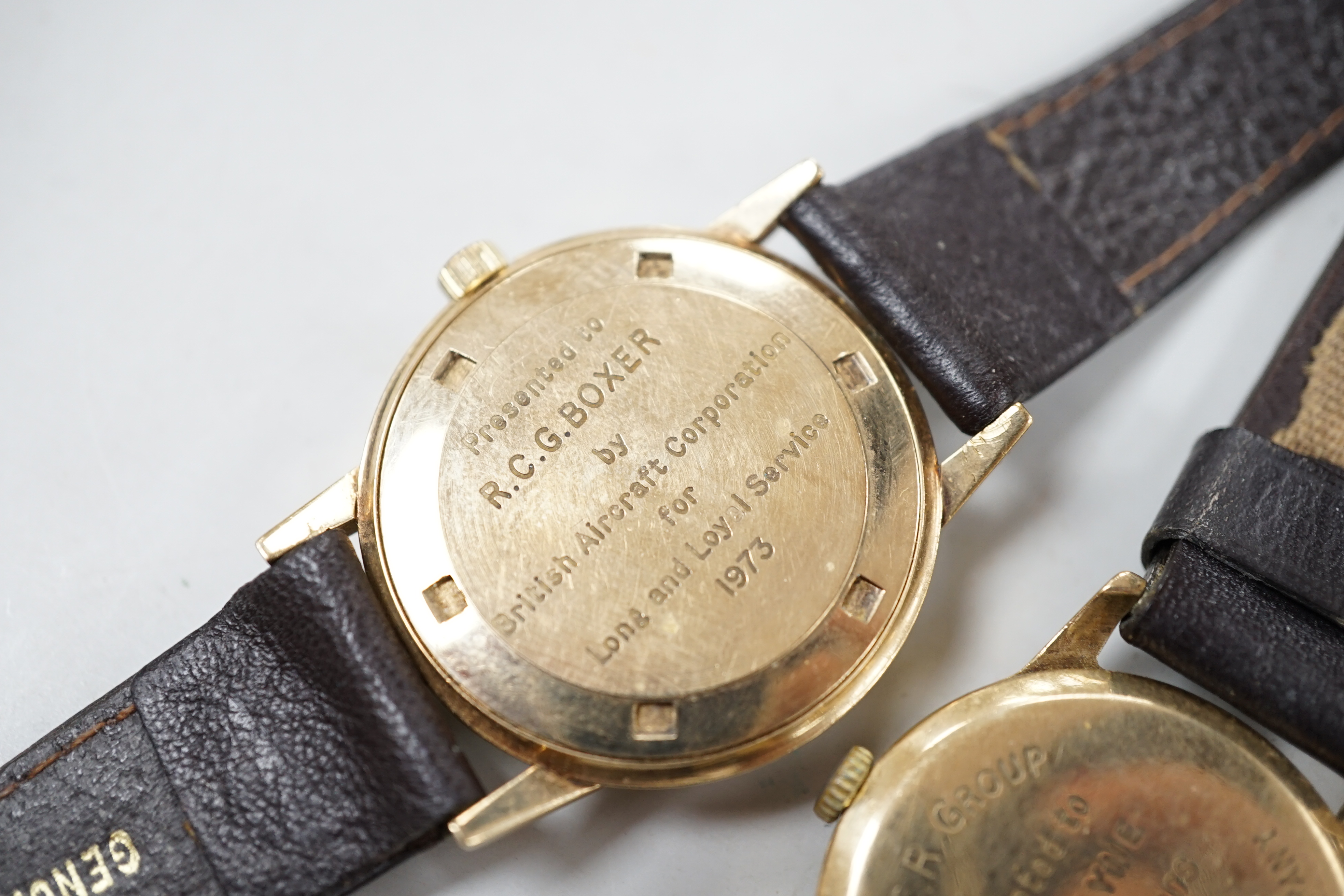 Two gentleman's 9ct gold manual wind wrist watches, retailed by Garrards, both with engraved inscription and two other 9ct gold wrist watches including Eterna.